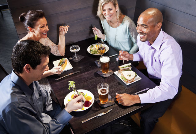 Two couples eating in a restaurant